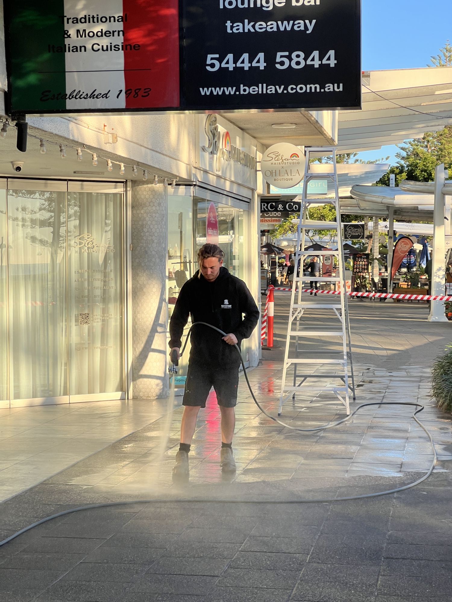 Pressure cleaning a shop front entry