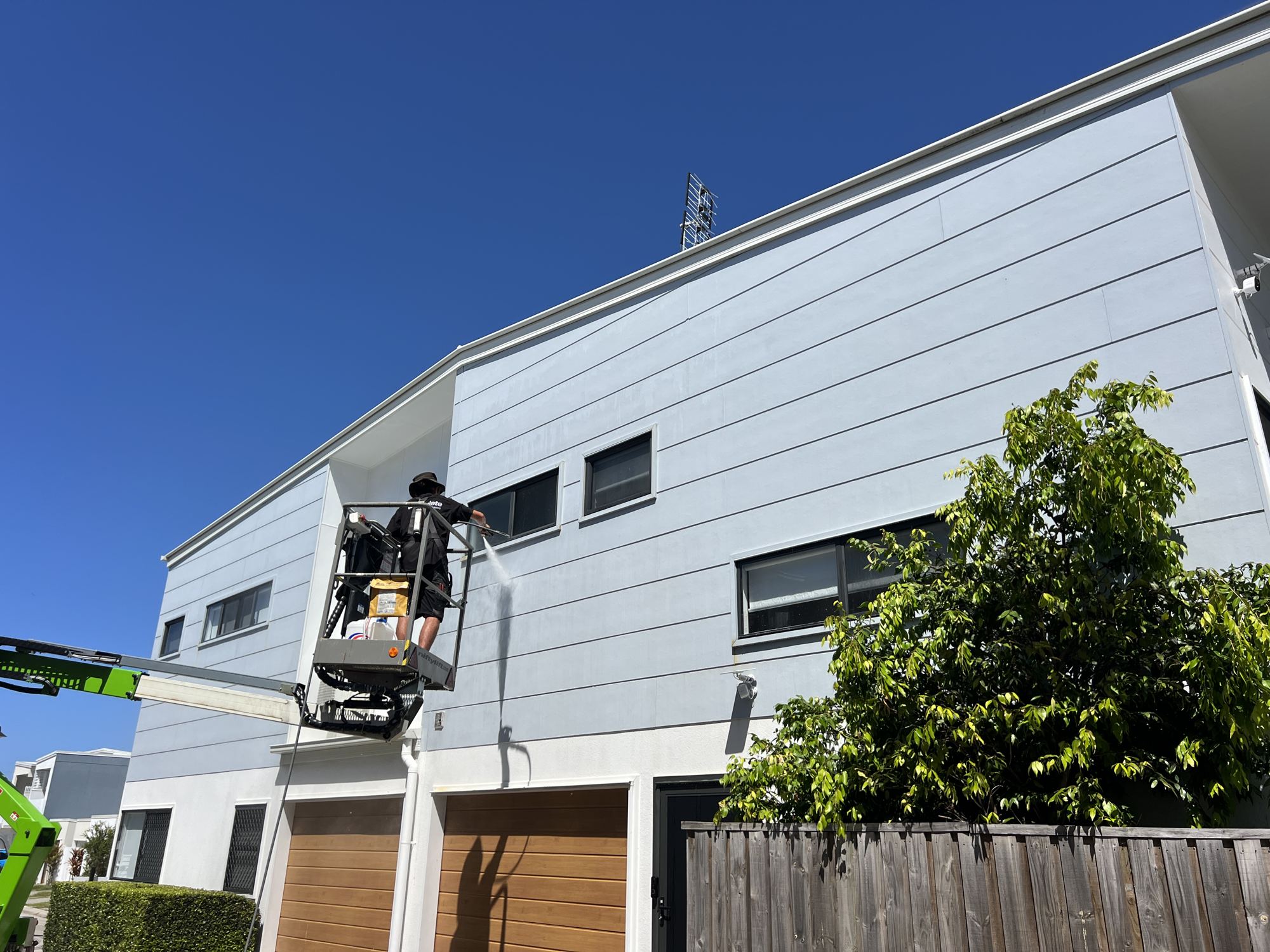Washing an apartment building from a lift at Meridan Plains